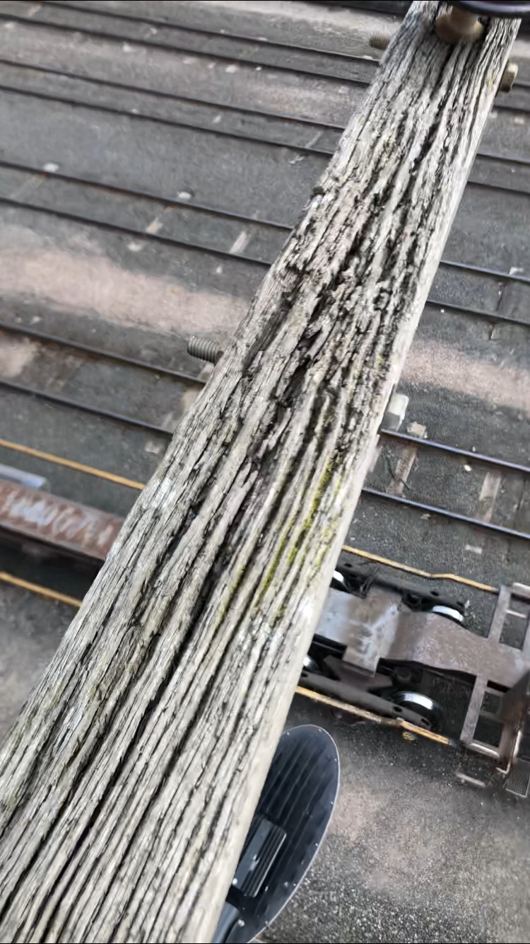 Rotten power pole crossarm viewed with remote camera for a high voltage maintenance audit